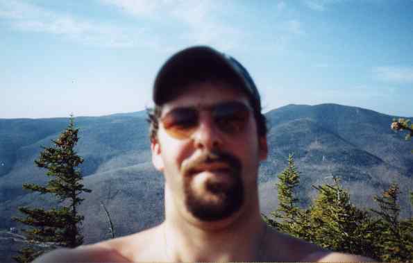 Photo of self with Presidential Range in background from summit Mt. Crawford, White Mountains, New Hampshire